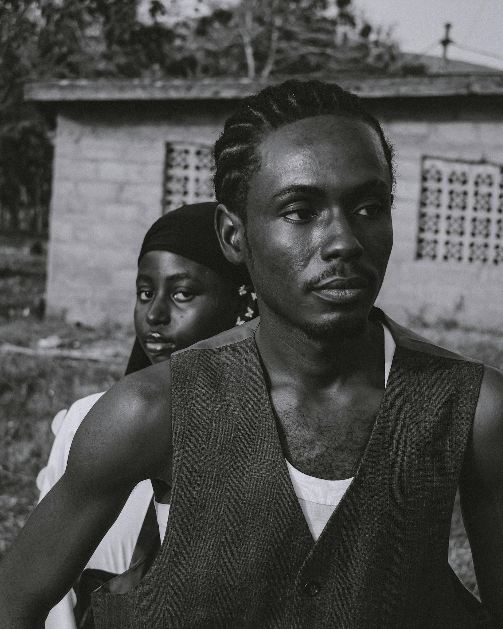 Black and white portrait of a man and woman with a rural backdrop.