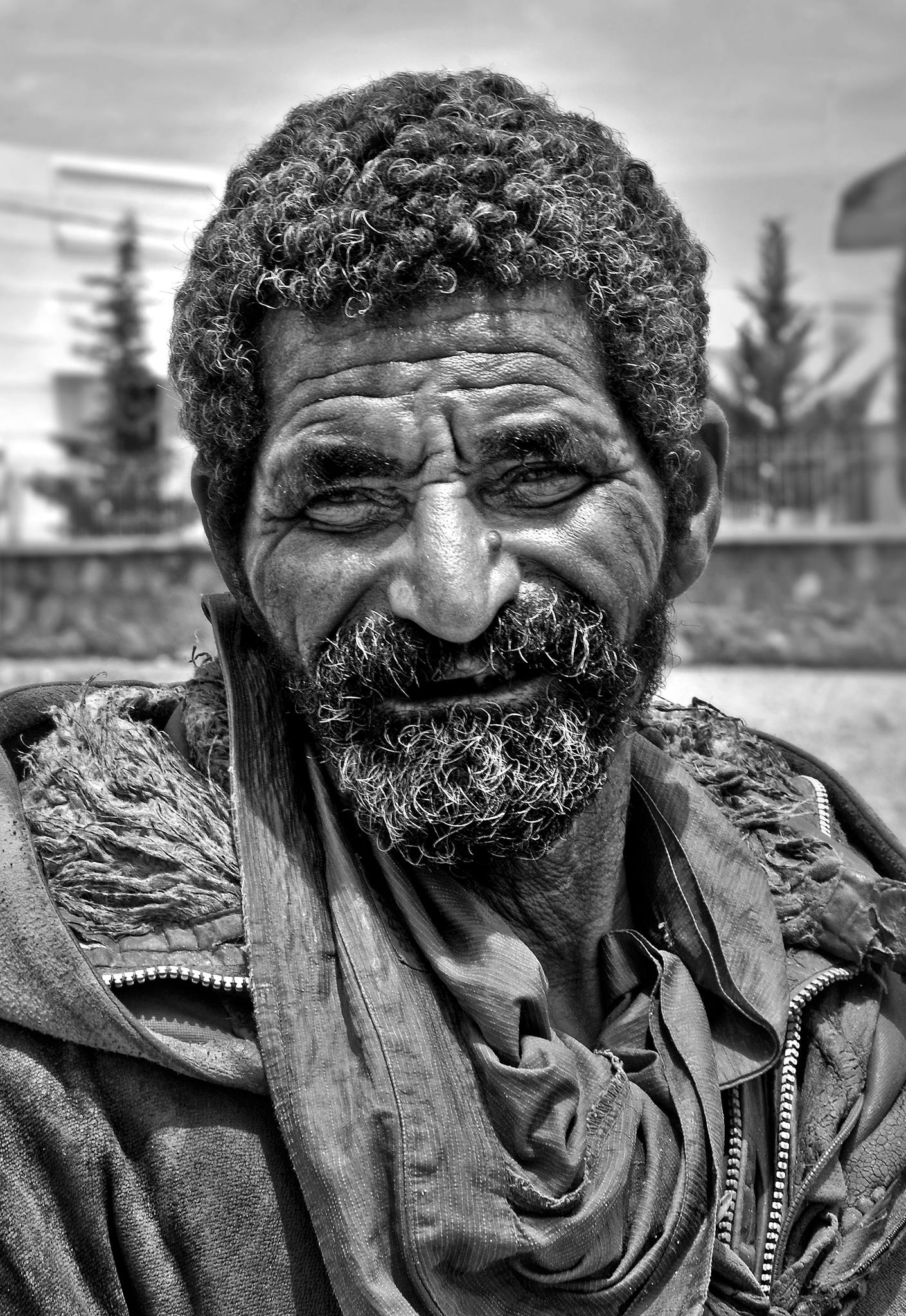 Black and white portrait of an elderly man in Guercif, Morocco, capturing a weathered expression.